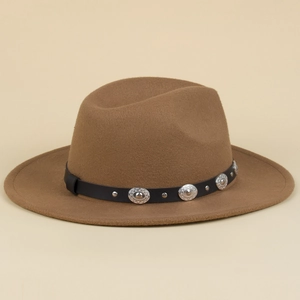 Detail of brown fedora hat featuring black leather band with silver studs and buckles