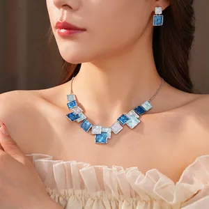 Elegant blue square enamel jewelry set including necklace and earrings on female model