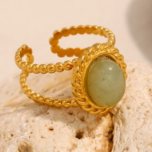 Macro detail of 18K gold-plated double-layer beaded ring with oval green aventurine stone