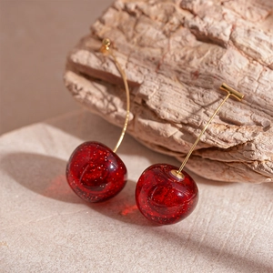 Deep red resin cherry earrings with glitter finish and long gold posts for women