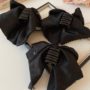 Detailed set of black glitter bow hair claws with rhinestone pendants and beaded edges