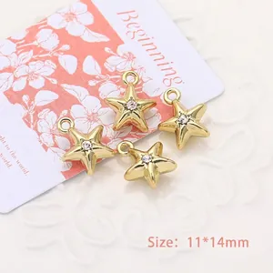 Detailed macro view of four golden star-shaped charms with rhinestones for DIY jewelry making