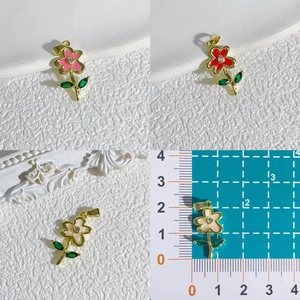 Daisy flower pendants in pink red and white colors shown with a ruler for size
