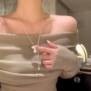 Collier avec pendentif perle baroque et chaîne argentée porté par une femme