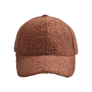 Close-up of caramel fleece baseball cap showing soft teddy velvet texture and stitch detail