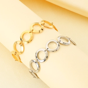 Detailed view of interconnected 18K gold and silver plated stainless steel chain bracelets