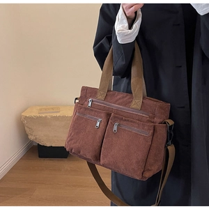 Brown corduroy tote bag with multiple zipper pockets and adjustable shoulder straps