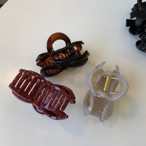 Three-piece hair claw clips in burgundy, amber and grey with golden springs