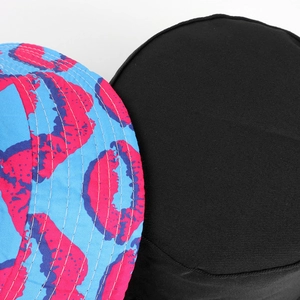 Close-up of lip print pattern and reinforced stitching on a reversible bucket hat