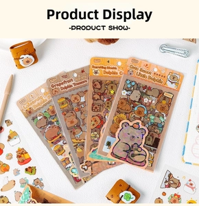 Close-up of four packs of cute Capybara waterproof PET stickers with various cartoon scenes