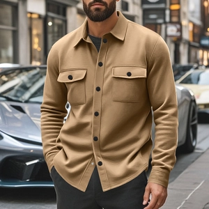 Detail of slim fit khaki casual jacket with dual chest pockets and contrast buttons