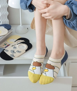 Detailed view of women's cartoon cotton invisible socks with yellow striped duck pattern