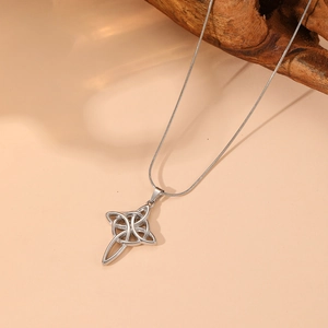 Silver Celtic knot necklace with opal and crystal pendant on a natural wooden display