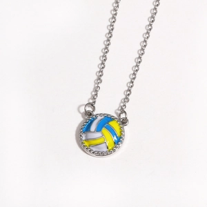 Macro view of volleyball pendant with blue, yellow, and white enamel on silver chain