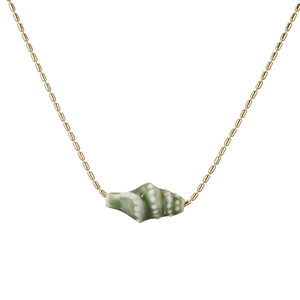 Detail of a golden bead chain necklace featuring a green and white ceramic conch pendant