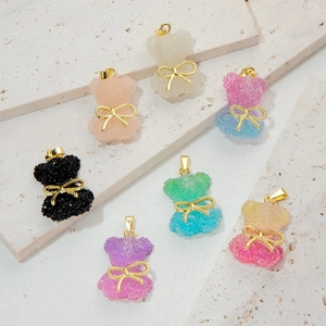 Cute crystal bear pendants with golden bowties in multiple gradient colors set on stone