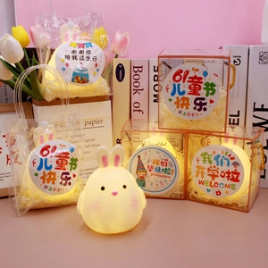 Detailed view of glowing rabbit night light in gift packaging with raffia and theme stickers