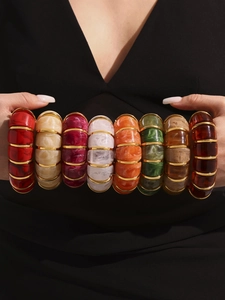 Detailed close-up of resin bamboo joint bracelets with 18k gold-plated metal spacers