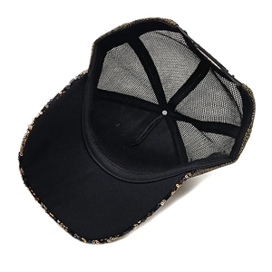 Detail view of the black mesh back and adjustable snap closure on a sequin trucker hat