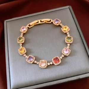 Detail of 18k gold plated bracelet featuring multicolor square zircons on velvet