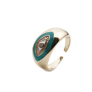 Detailed macro of gold plated adjustable evil eye ring with green enamel and zircon