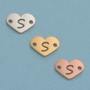 Detail of 12mm mirror heart charms with hollow letter S in silver, gold and rose gold