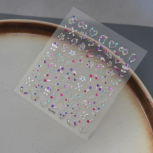 Detailed silver 3D nail sticker with stars and heart rhinestones on a white plate