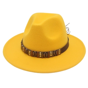 Detail of yellow wool fedora hat with bohemian studded leather band and shell accents