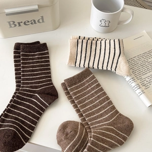 Three pairs of wool mid-calf striped socks in warm earth tones for autumn and winter