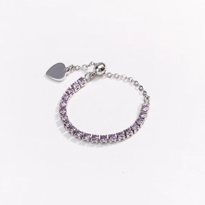 Detail of adjustable silver ring with purple cubic zirconia stones and heart charm