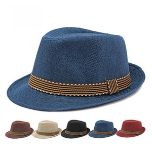 Detail view of breathable mesh texture and striped band on a summer fedora hat