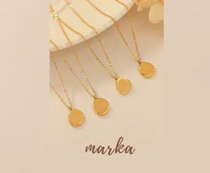 Detailed close-up of 18K gold-plated irregular oval pendant necklaces with hammered texture