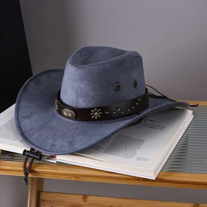Dark blue vintage cowboy hat with wide brim and decorative leather band on magazines