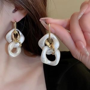 Chic gold chain earrings with irregular white acrylic rings for women in a stylish design
