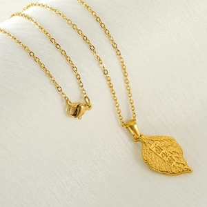 18k gold-plated stainless steel leaf necklace with fortune engraving on silk background