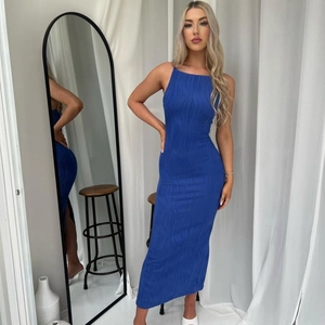 Detail of royal blue bodycon maxi dress with vertical textured pleats and sleek silhouette