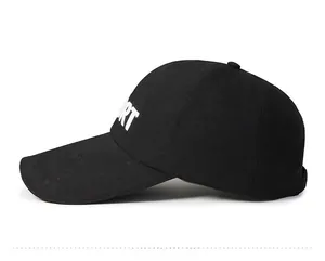 Side view of black cotton baseball cap with white SPORT lettering and long sun visor