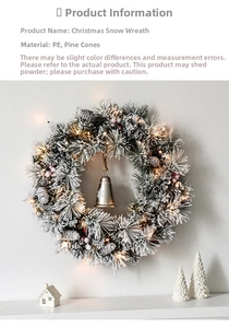 Close-up of snowy Christmas wreath with pine cones, red berries and festive LED lights