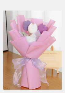 Detail of hand-knitted 3-flower tulip bouquet in purple and white with pink wrap