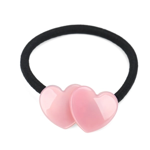 Pink heart-shaped charms on black elastic hair tie shown on a clean white background