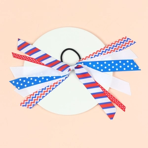 Detailed view of American flag style ribbon hair tie with red white and blue stars