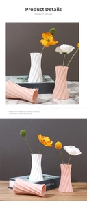 Detailed view of modern spiral geometric textured ceramic vases in white and pink matte finish
