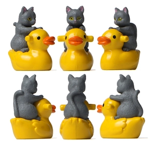 Detail view showing a grey cat figurine riding a yellow duck from six different angles