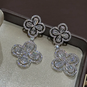 Detail of silver clover earrings with sparkling cubic zirconia pavé in a jewelry box