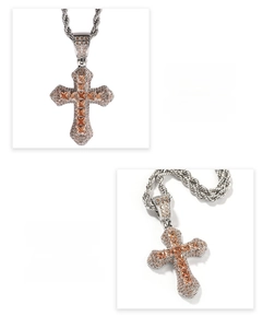 Macro view of hip hop cross pendant with orange cubic zirconia and rope chain detail