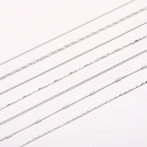 Detail of silver box, snake, and water wave chain necklaces in multiple link styles