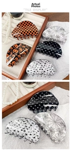 Detailed set of Halloween acrylic hair claws with pumpkin, skull, and spider patterns