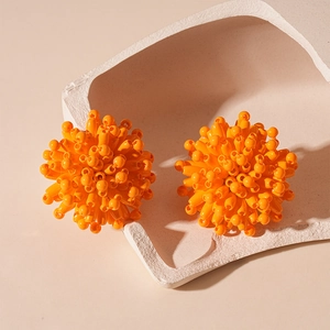 Vibrant orange beaded cluster stud earrings featuring a textured sphere design