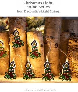 Detail of LED Christmas string lights with iron candle leaf pendants on wood