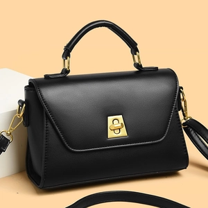 Elegant black leather square shoulder bag with gold rotating metal lock, 45-degree view